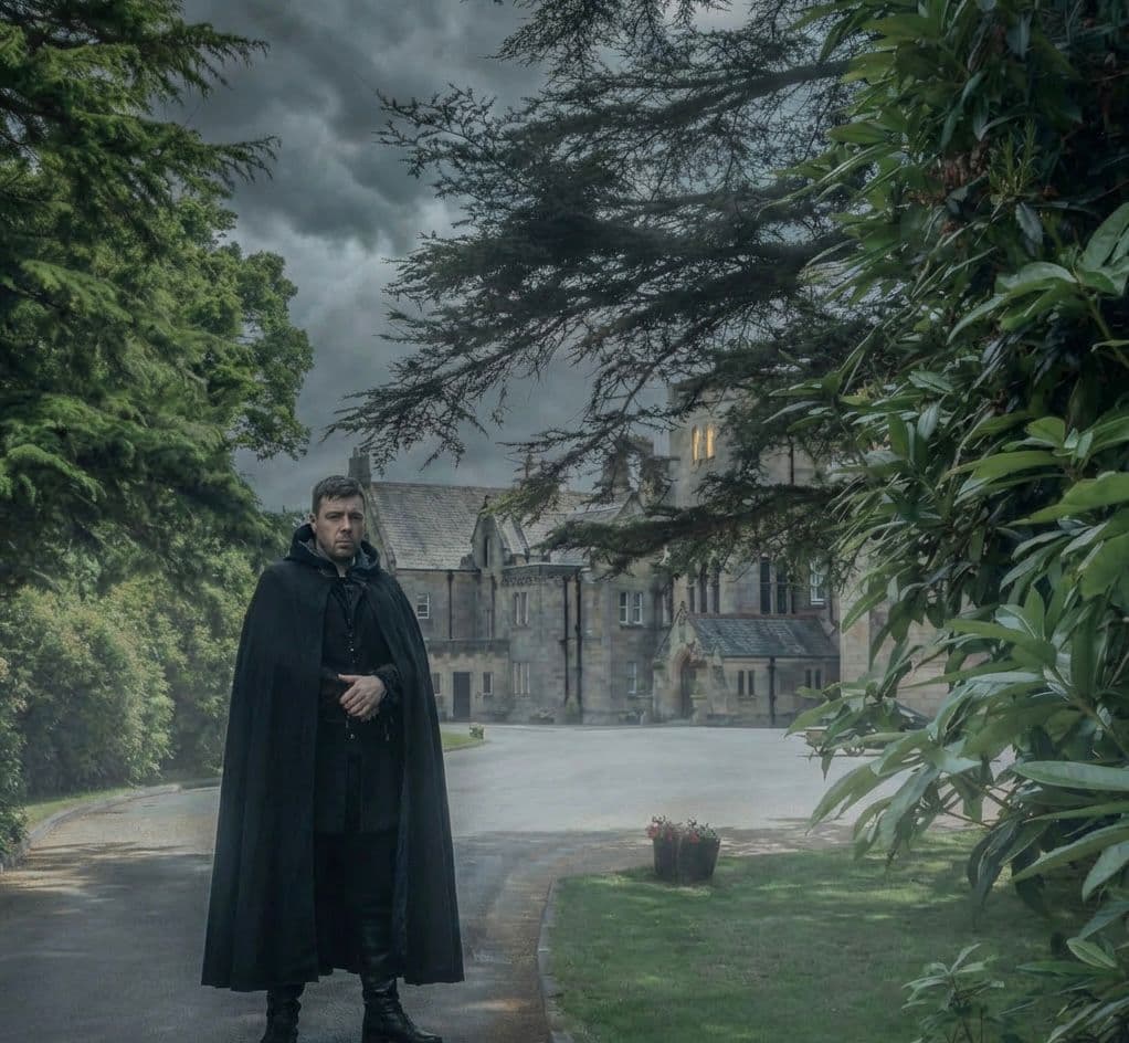 A cloaked figure before Grinkle Park manor at dusk